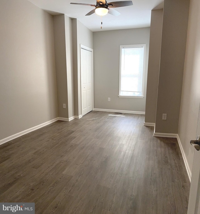 spare room featuring dark hardwood / wood-style floors and ceiling fan