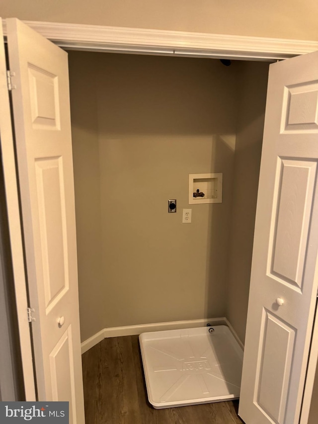 clothes washing area featuring dark hardwood / wood-style floors, hookup for a washing machine, and electric dryer hookup