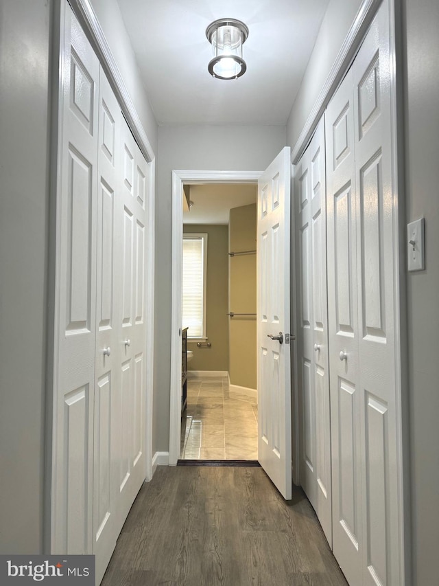 corridor with dark hardwood / wood-style floors