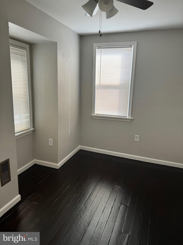 empty room featuring dark hardwood / wood-style floors and ceiling fan