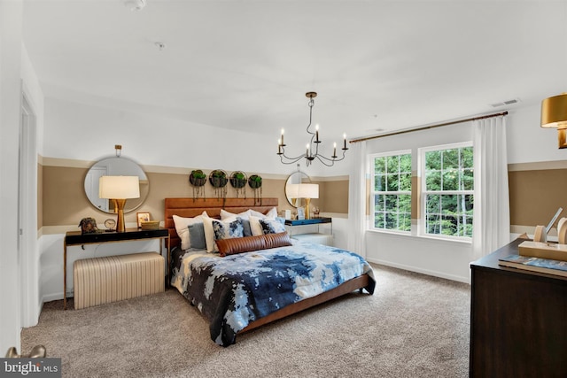 bedroom with a chandelier and light colored carpet