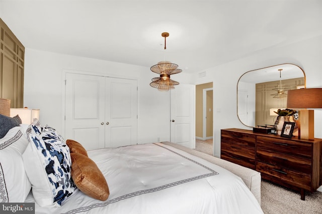 bedroom with a closet and light colored carpet