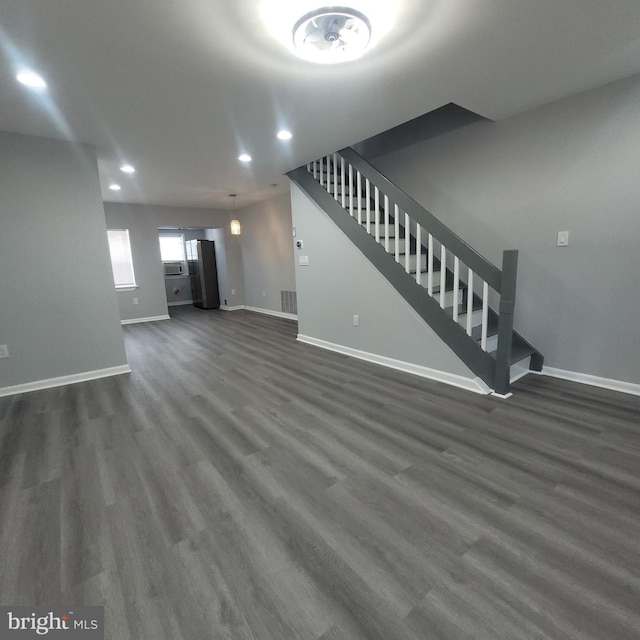 unfurnished living room featuring dark hardwood / wood-style flooring