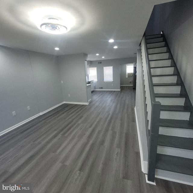 basement with dark hardwood / wood-style floors