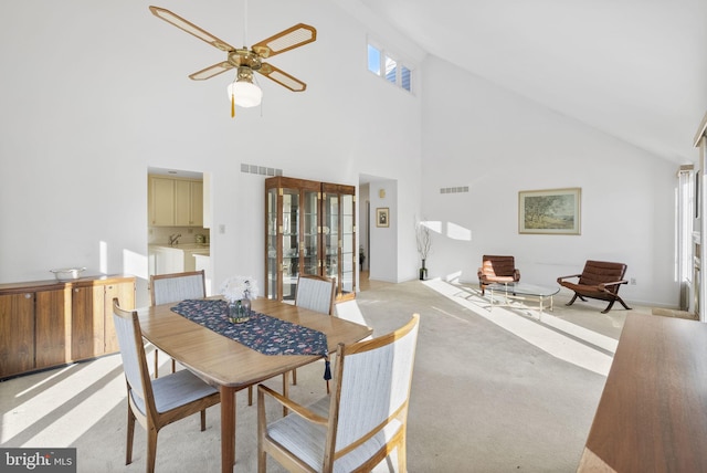 dining area with light colored carpet and ceiling fan