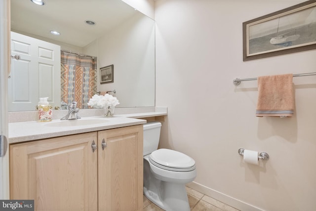 bathroom featuring vanity, toilet, and tile patterned flooring