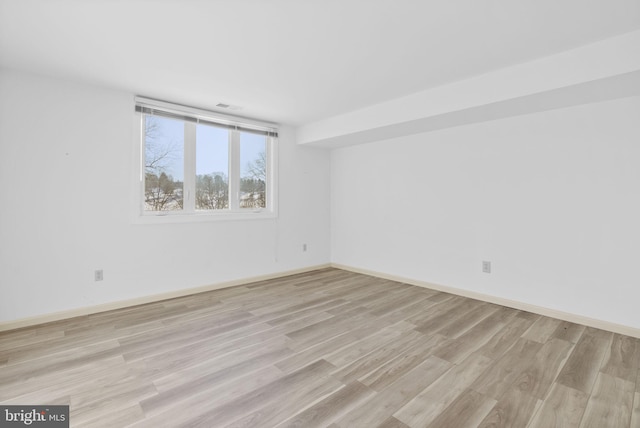 spare room featuring light hardwood / wood-style floors