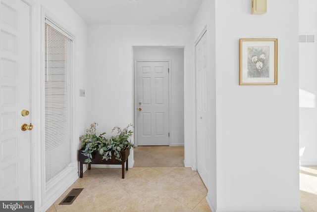 hall with light tile patterned floors