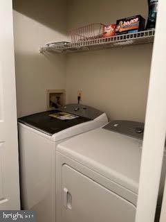 washroom featuring washer and clothes dryer