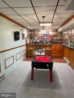 playroom featuring bar area, carpet flooring, and a baseboard radiator