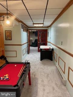 game room featuring light colored carpet and ornamental molding