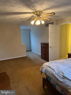 bedroom with carpet flooring, ceiling fan, and a textured ceiling