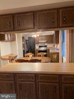 kitchen with dark brown cabinets and range