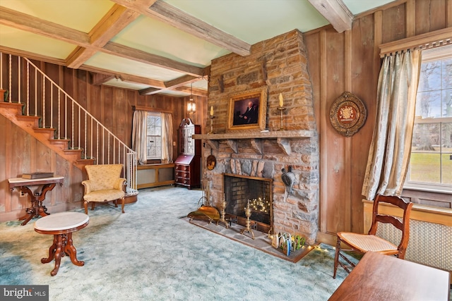 carpeted living room with a fireplace, coffered ceiling, beamed ceiling, and wood walls