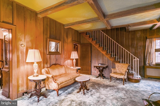 living room with beamed ceiling, carpet flooring, radiator, and coffered ceiling