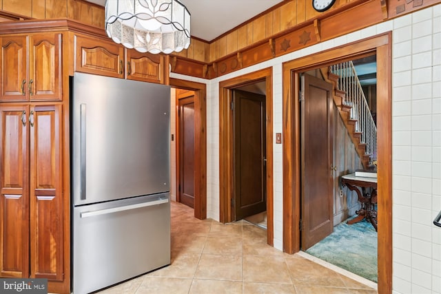 kitchen with stainless steel fridge and light tile patterned floors