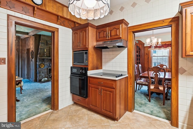 kitchen with crown molding, light colored carpet, black appliances, and an inviting chandelier