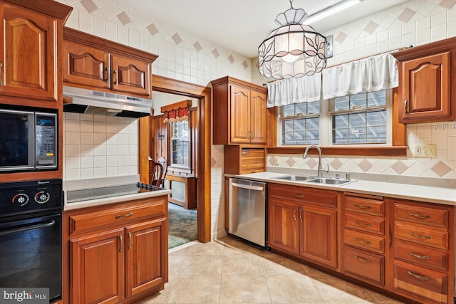 kitchen with built in microwave, sink, dishwasher, oven, and hanging light fixtures