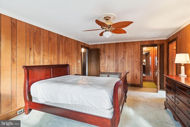 carpeted bedroom featuring ceiling fan and ornamental molding