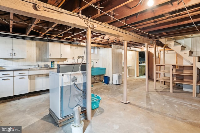 basement featuring separate washer and dryer and sink