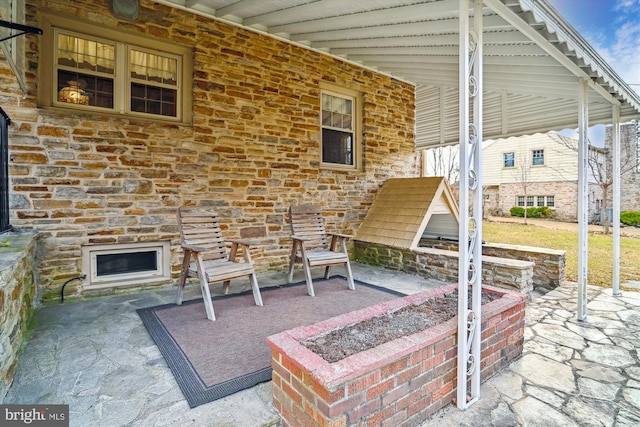 view of patio / terrace with an outdoor fire pit