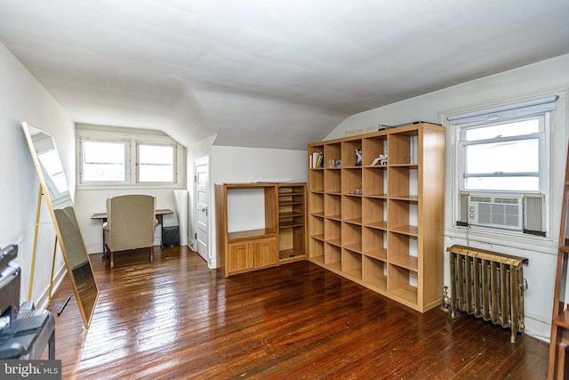 additional living space featuring lofted ceiling, radiator, dark wood-type flooring, and cooling unit