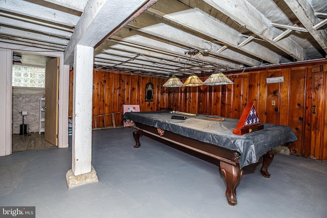 recreation room with pool table, concrete floors, and wood walls