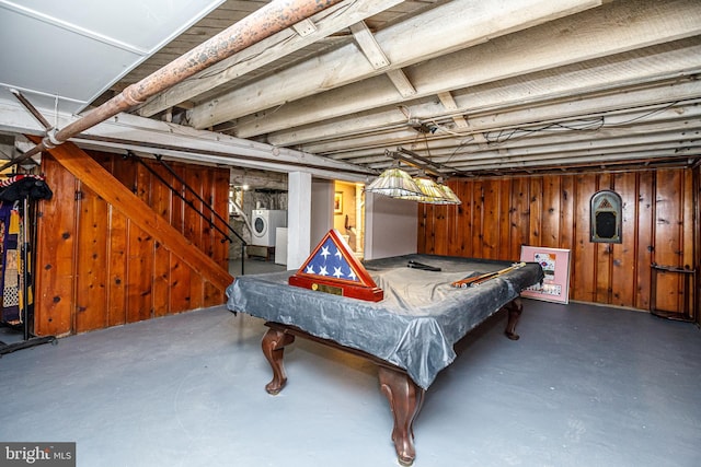 recreation room with billiards, washing machine and dryer, and wood walls