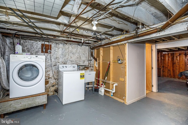 basement featuring sink and washer and dryer