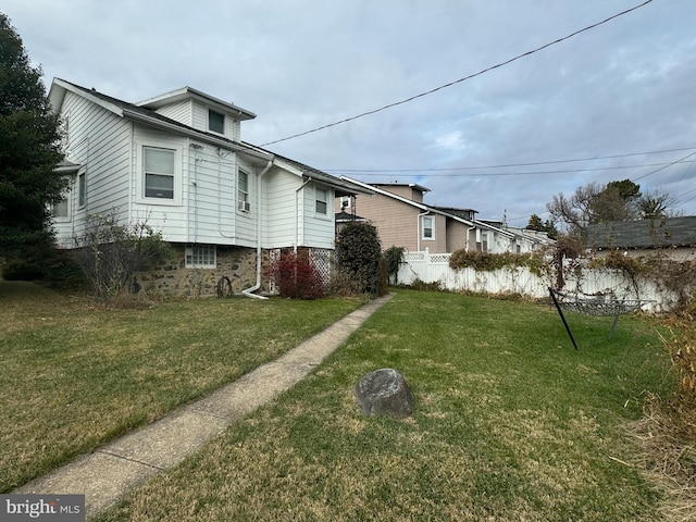 view of side of home featuring a yard