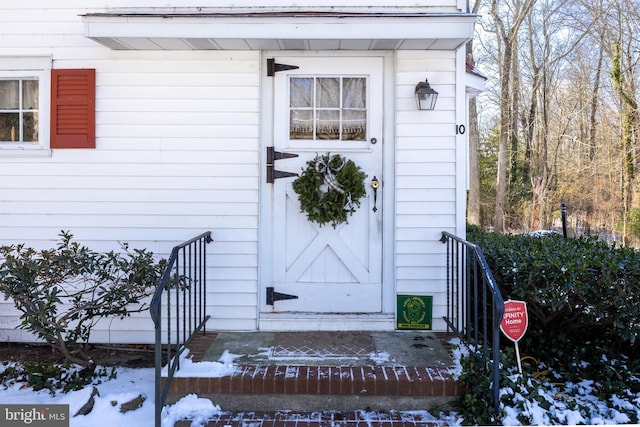 view of snow covered property entrance