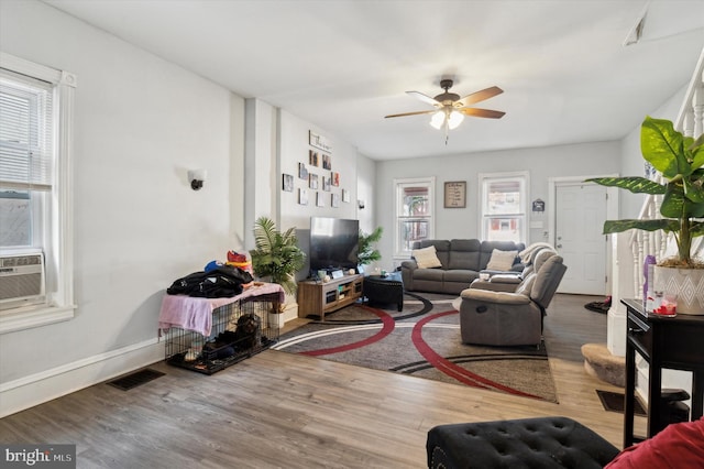 living room featuring ceiling fan, a healthy amount of sunlight, and wood-type flooring