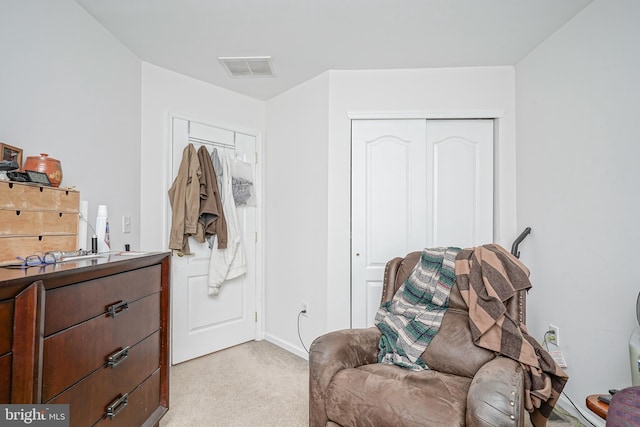 sitting room featuring light colored carpet