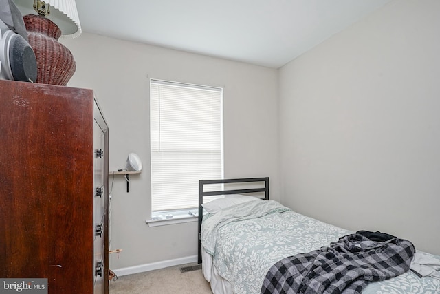 bedroom featuring light colored carpet