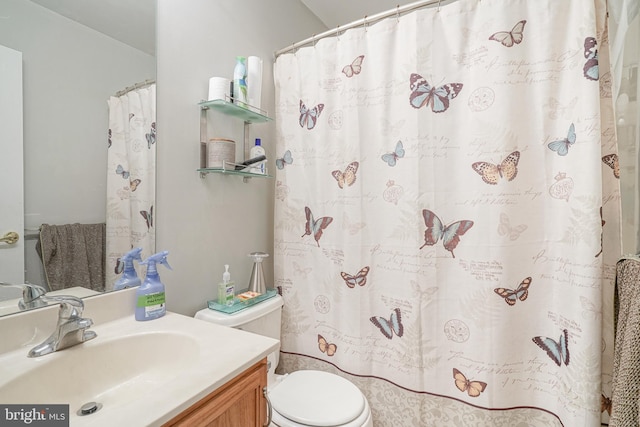 bathroom featuring vanity and toilet