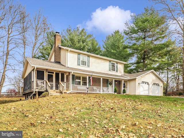 view of front facade featuring covered porch, a front yard, and a garage