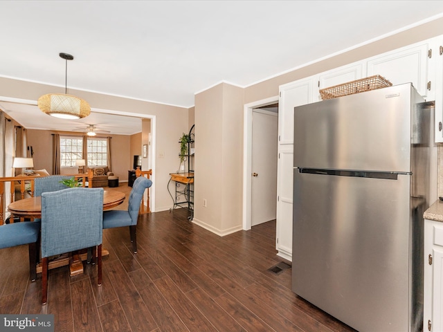 dining area with ceiling fan and dark hardwood / wood-style flooring