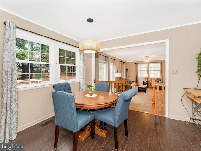 dining area with dark hardwood / wood-style floors and ceiling fan