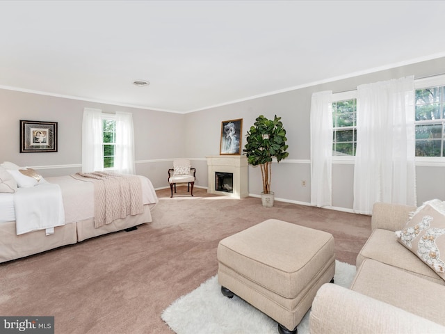 carpeted bedroom featuring multiple windows and crown molding