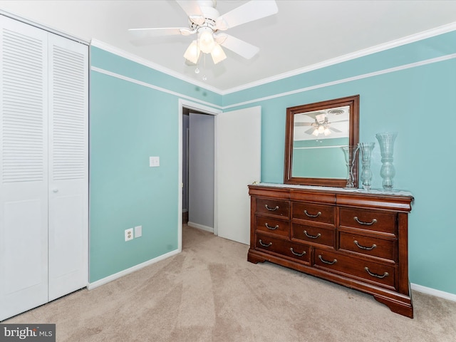 unfurnished bedroom featuring light carpet, a closet, ceiling fan, and ornamental molding