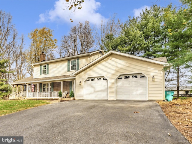 view of front of house featuring covered porch and a garage