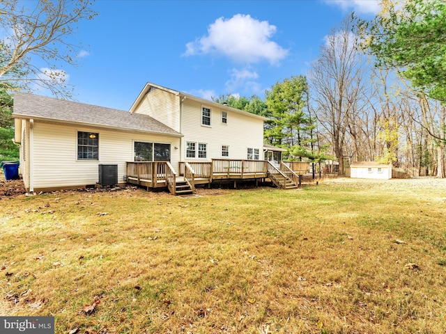 back of house with a storage unit, a yard, and a wooden deck