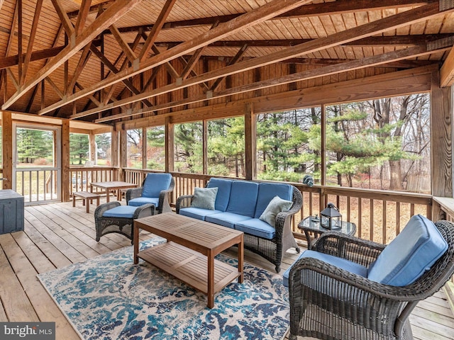 sunroom / solarium featuring vaulted ceiling with beams and wood ceiling