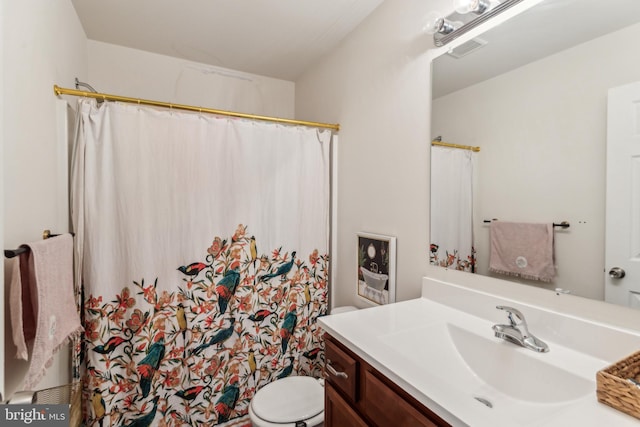 bathroom with walk in shower, vanity, and toilet