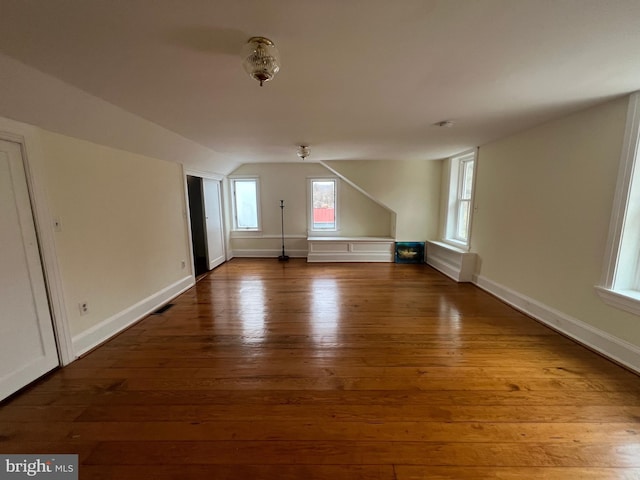 bonus room featuring hardwood / wood-style floors and vaulted ceiling