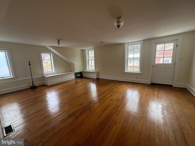 additional living space featuring hardwood / wood-style flooring