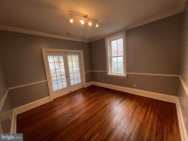 spare room with crown molding and dark wood-type flooring