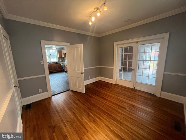 unfurnished dining area featuring dark hardwood / wood-style floors and ornamental molding