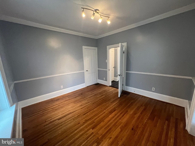 spare room with dark hardwood / wood-style flooring and ornamental molding