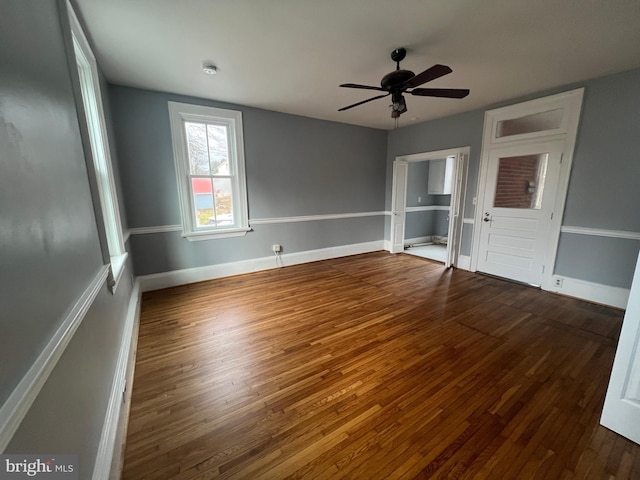 empty room featuring ceiling fan and dark hardwood / wood-style floors